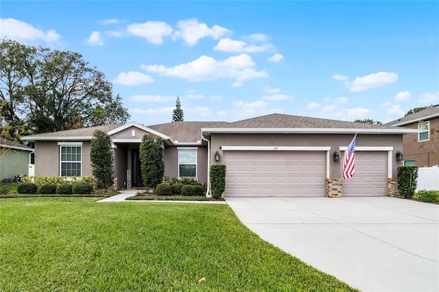 single story home featuring a garage and a front lawn