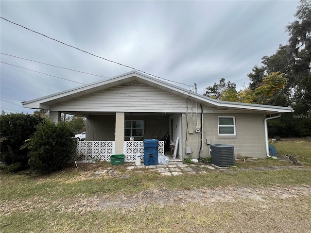 rear view of property with central AC