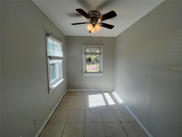 spare room with light tile patterned floors and ceiling fan