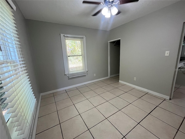 unfurnished bedroom featuring light tile patterned floors and ceiling fan