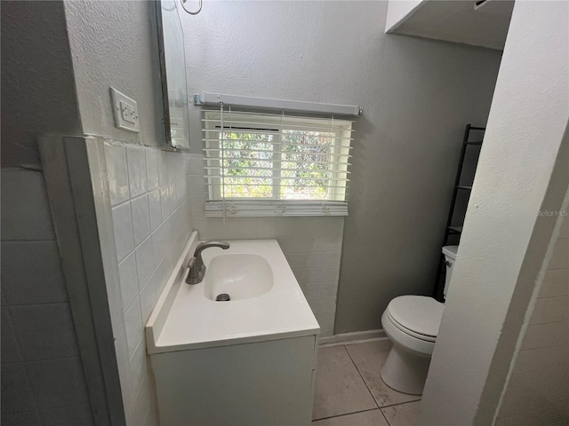 bathroom featuring vanity, toilet, and tile patterned flooring