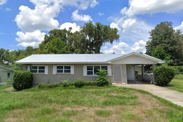 ranch-style house with a carport and a front yard