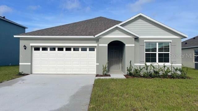 single story home with a front yard and a garage