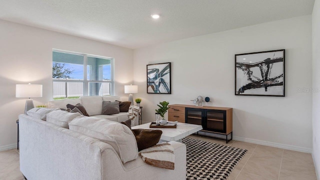 tiled living room featuring a textured ceiling