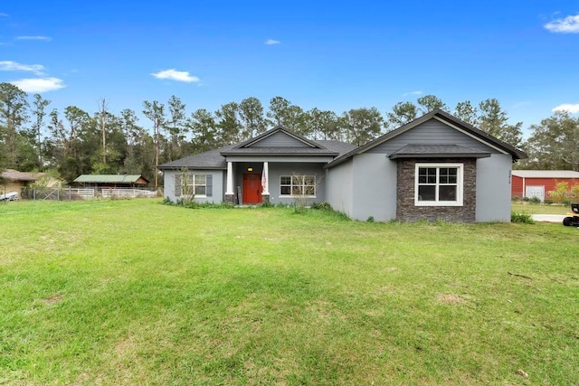 view of front of home with fence and a front lawn