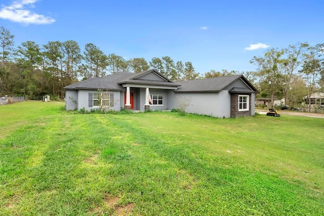 ranch-style home featuring a front yard and stucco siding