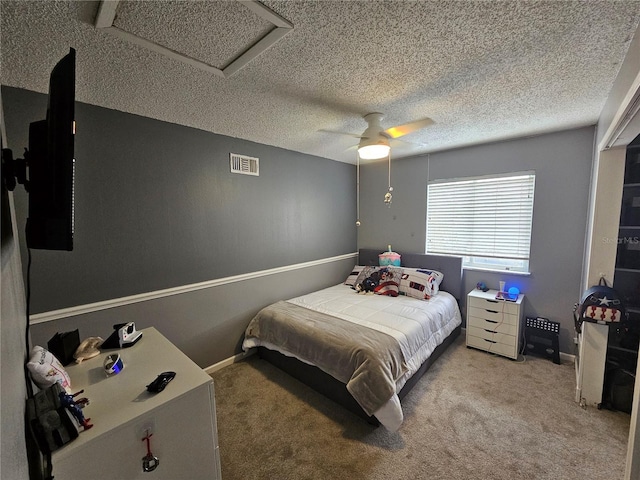 carpeted bedroom featuring a textured ceiling and ceiling fan