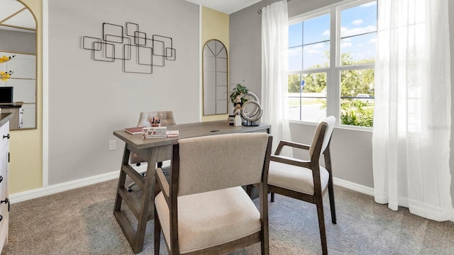 carpeted dining area featuring plenty of natural light