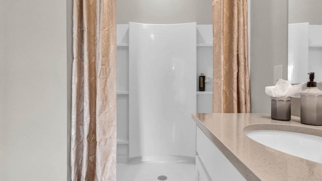 bathroom with a shower with shower curtain and vanity