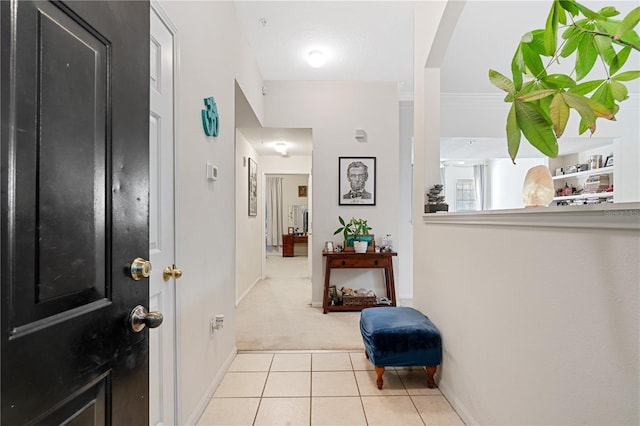 hall featuring light colored carpet