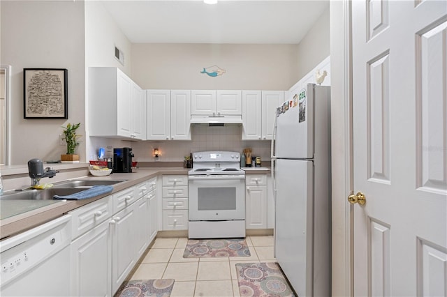 kitchen with sink, white cabinets, decorative backsplash, light tile patterned floors, and white appliances