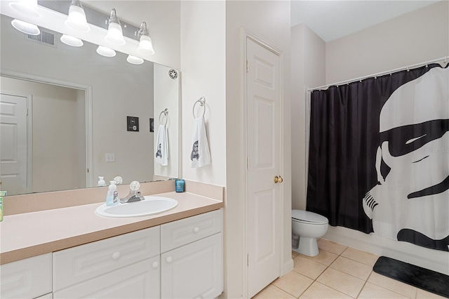 full bathroom featuring shower / bath combo with shower curtain, tile patterned floors, toilet, and vanity