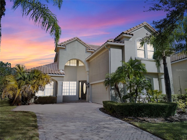 mediterranean / spanish-style house with a garage