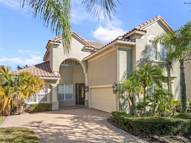 mediterranean / spanish-style home featuring a garage