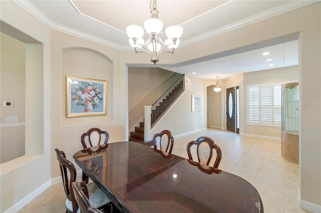 dining area featuring an inviting chandelier, ornamental molding, and light tile patterned flooring