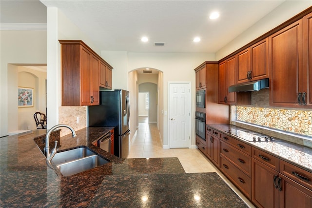 kitchen featuring light tile patterned flooring, backsplash, black appliances, and sink