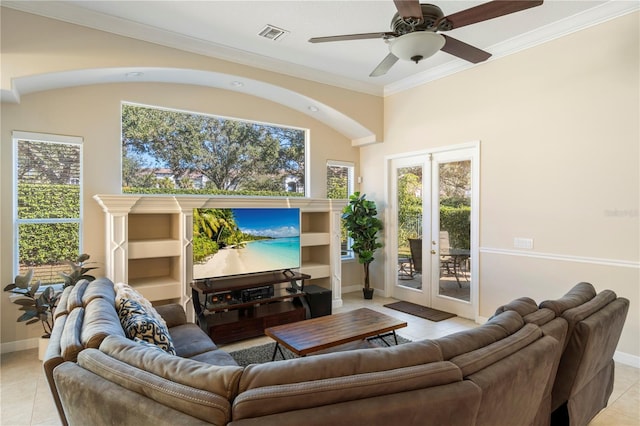 tiled living room with ceiling fan, french doors, and crown molding