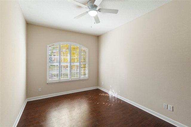 spare room featuring dark hardwood / wood-style floors and ceiling fan