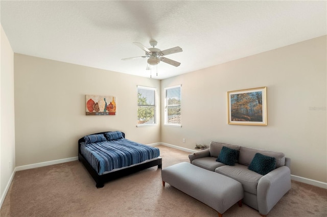 bedroom with ceiling fan and light colored carpet