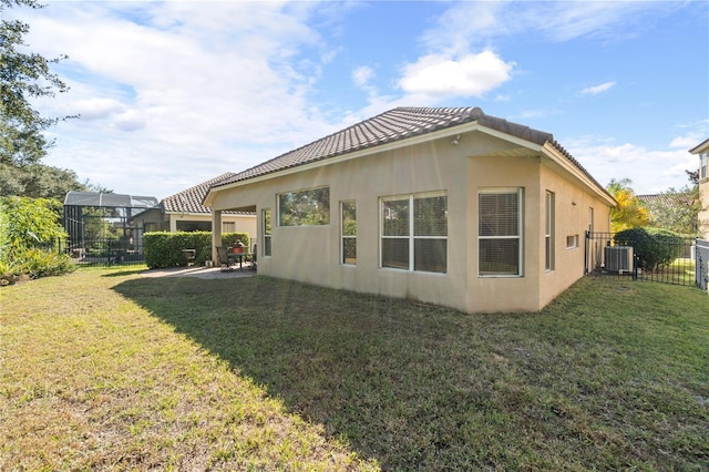 view of property exterior featuring a lanai, a lawn, and cooling unit