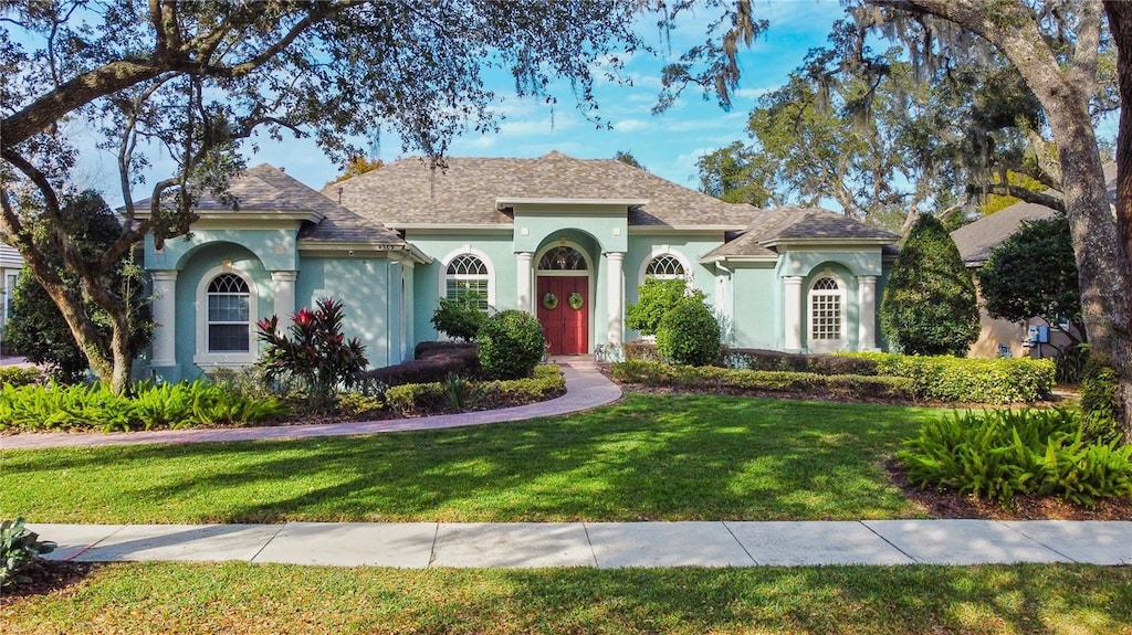 mediterranean / spanish house with a front lawn