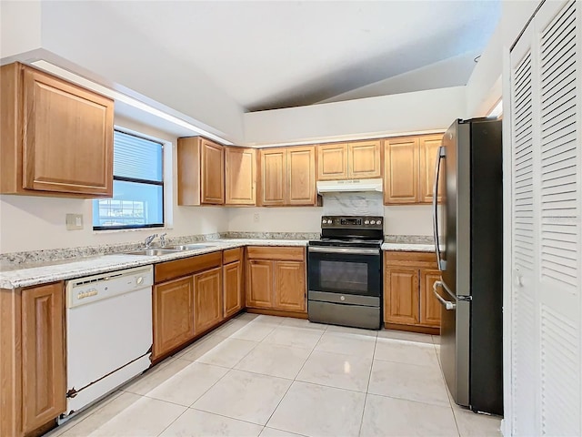 kitchen with light tile patterned floors, stainless steel appliances, vaulted ceiling, and sink