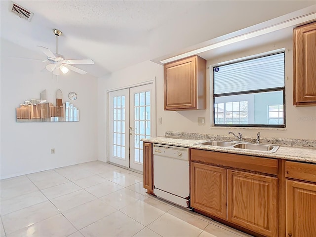 kitchen with french doors, white dishwasher, ceiling fan, sink, and light tile patterned flooring