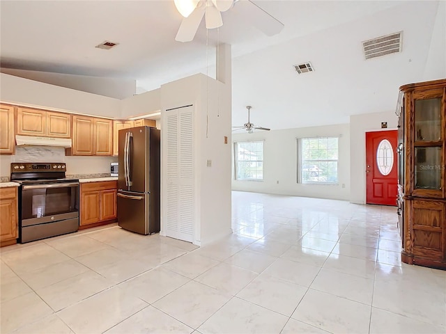 kitchen featuring ceiling fan, light tile patterned flooring, appliances with stainless steel finishes, and vaulted ceiling