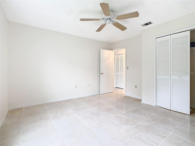 unfurnished bedroom featuring light tile patterned floors, a closet, and ceiling fan