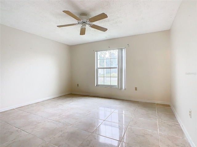 spare room with ceiling fan and a textured ceiling