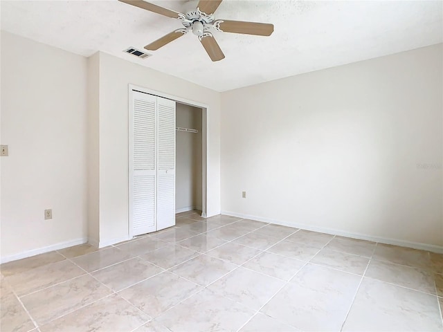 unfurnished bedroom featuring ceiling fan, light tile patterned floors, and a closet