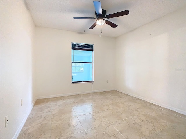 spare room featuring ceiling fan and a textured ceiling