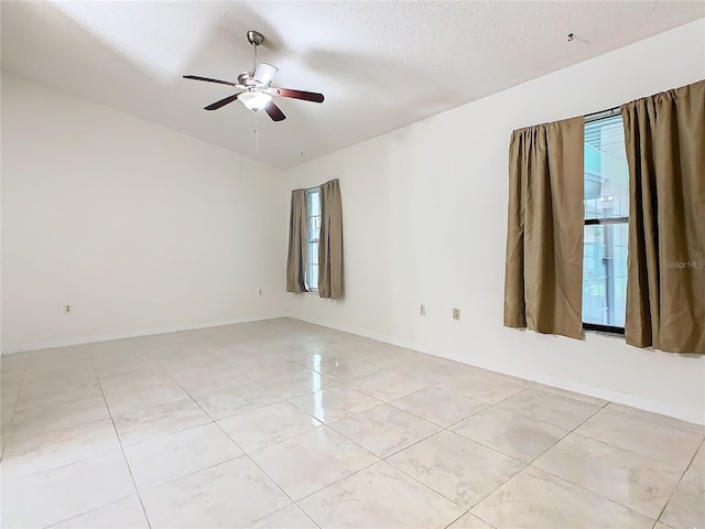 spare room with ceiling fan and a textured ceiling