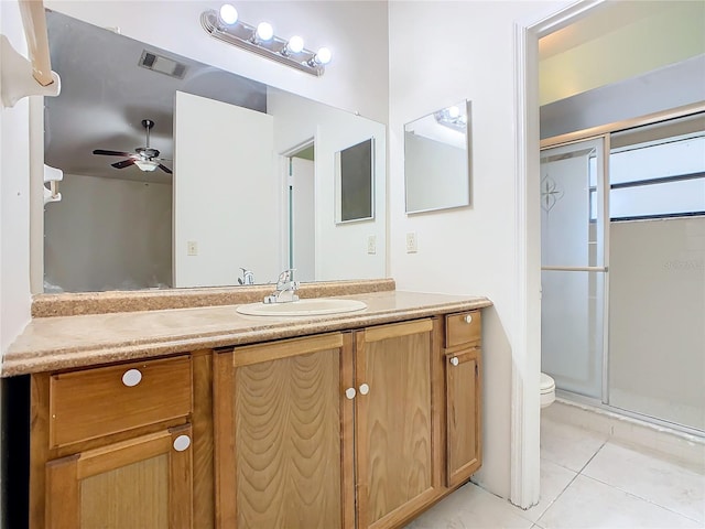 bathroom featuring tile patterned floors, walk in shower, vanity, ceiling fan, and toilet