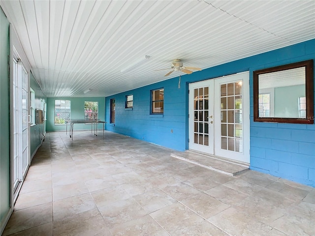 unfurnished sunroom featuring french doors and ceiling fan