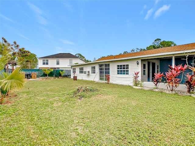 back of property featuring a lawn