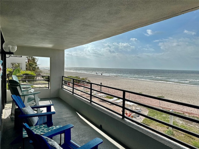 balcony with a view of the beach and a water view