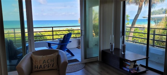 balcony featuring a water view and a beach view