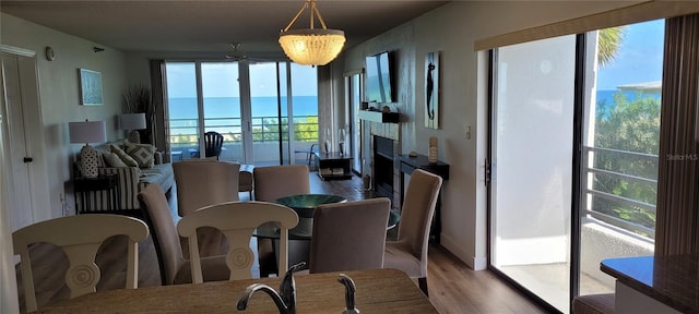 dining space featuring ceiling fan with notable chandelier and light hardwood / wood-style floors