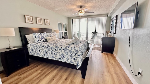 bedroom featuring access to exterior, a textured ceiling, light hardwood / wood-style floors, and ceiling fan