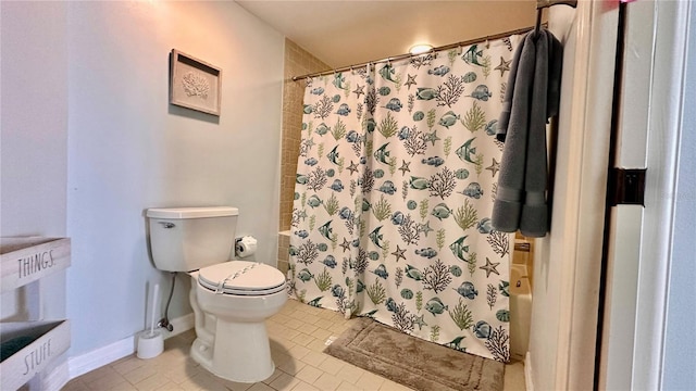 bathroom with tile patterned flooring, a shower with shower curtain, and toilet