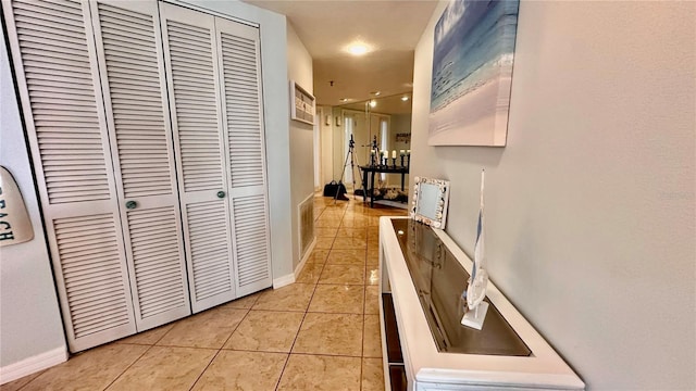 hallway featuring light tile patterned flooring