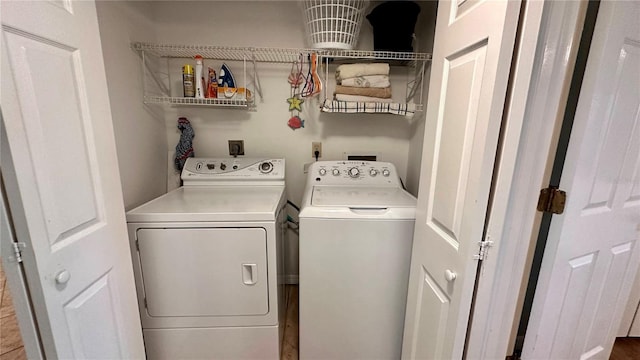 clothes washing area with separate washer and dryer