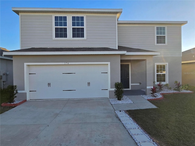 view of front property featuring a garage and a front yard