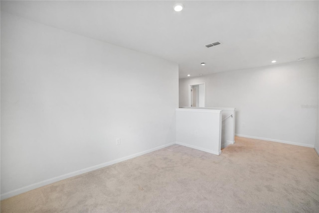 spare room featuring light colored carpet