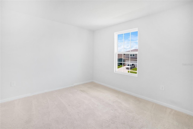 unfurnished room featuring light carpet