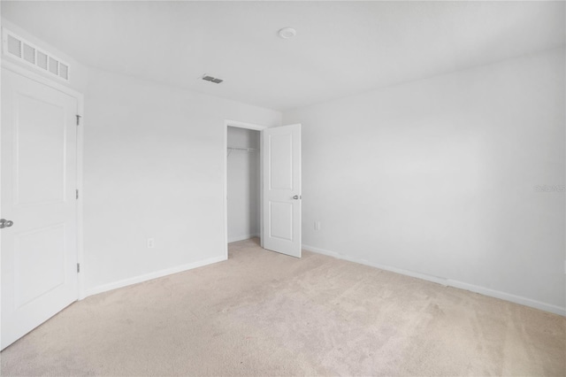 spare room with light colored carpet