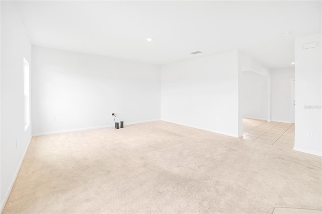 unfurnished room with light carpet