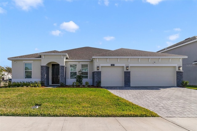 view of front of home with a garage and a front lawn