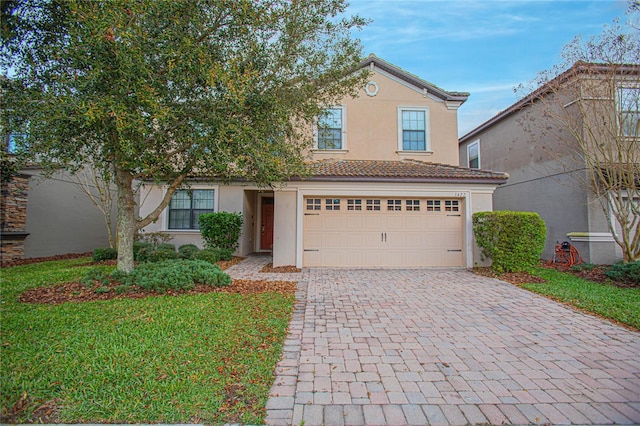 view of front of home featuring a front yard and a garage